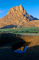 Peak of Spitzkoppe reflected in temporary pool in rain season, Namib Desert, Namibia 1997