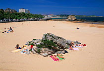 People sunbathing, Santander beach, Cantabria, north coast of Spain