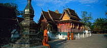 Monks and classic Lao Temple Architecture, Wat Xieng Thong, Luang Prabang, Laos
