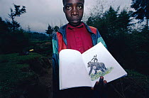 Child with drawing of Mountain gorilla, Parc des Volcans NP, Rwanda. encourages involvement in wildlife conservation