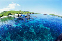 Traditional outrigger boat on coastal waters off Komodo Island, Flores, Indonesia