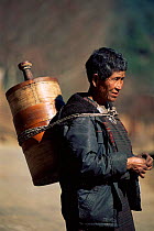 Bhutanese woman carrying butter churn, Gantay Gompa, Phobjika Valley, Central Bhutan 2001