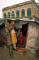 Family living in tiny shack, street scene from Calcutta, West Bengal, India