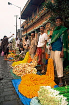 People selling flower garlands on street, Calcutta flower market, West Bengal, India