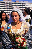 Woman in traditional costume with flower offerings, Fallas Valencia Festival 2003, Spain