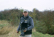 Camerman Paul Johnson filming on location, UK, 2003 (d. 2004)