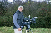 Camerman Paul Johnson filming on location, UK, 2003 (d. 2004)