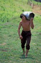 Shepherd carrying milk urn, Transylvania, Romania