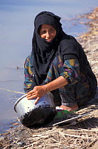 Marsh arab woman washing dish Iran / Iraq border, 1998