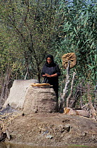 Marsh arab woman cooking at traditional oven Iran / Iraq border, 1998