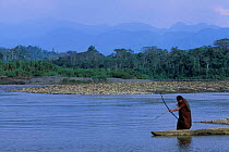 Machiguenga indian fishing with bow + arrow, Timpia community, Urubamba river, Amazonia, Peru
