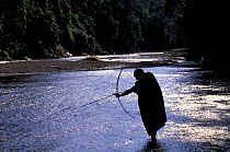 Machiguenga indian fishing with bow and arrow, Timpia community Urubamba river, Amazonia, Peru