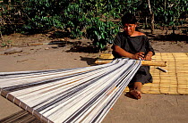 Woman of the Campa indian tribe weaving a kushma (robe), Lower Urubamba river, Amazonia, Peru