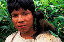 Indian boy with Woolly monkey as pet, Boca mishuagua river, Amazonia, Peru