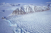 Heavily crevassed glacier (right) meets frozen sea ice (left) Svalbard, Norway