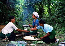 Khamti women prepare a meal, NE India. Khamtis are of Burmese origin with a special ability to catch and train elephants.