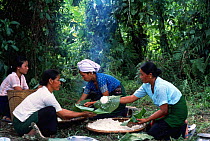 Khamti women prepare a meal, NE India. Khamtis are buddhists of Burmese origin with a special ability to catch and train elephants.