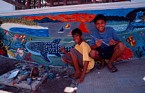 Children in  front of  wall mural painting during Donsol whale shark festival, Donsol, Philippines. 2003