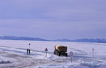 Lorry driving across frozen ice of Lake Baikal in winter, Siberia, Russia