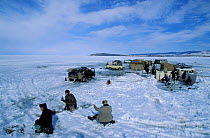 Fishermen at ice holes on Lake Baikal, Siberia, Russia