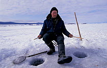 Fisherman at ice holes on Lake Baikal, Siberia, Russia