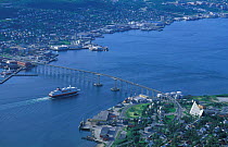 Aerial view of Tromso, Norway, with ferry approaching bridge.