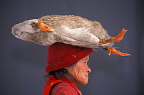 Shigu woman carrying goose on head, Yunnan province, China, 2002
