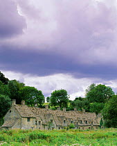 Medieval cottages +meadow, Arlington Row, Bibury, Cotswolds, Glos, UK 2003