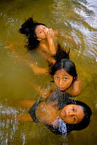 Maya children playing in water, Lacandon rainforest, Chiapas, Mexico