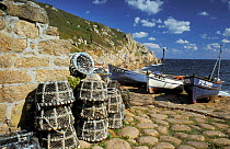 Fishing boats and lobster pots on shore, Penberth Cove, Cornwall, UK