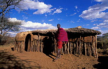 Masai tribesman outside hut. Kenya