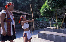 Aborigine of the Bunun tribe practise archery skills using animal ear as target, Taiwan