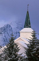 Reine church with magpie on spire Lofotens Norway