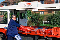 Milkman delivering milk, England