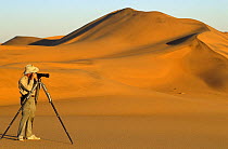 Photographer taking pictures in Nauklift Desert, Namibia, Southern Africa