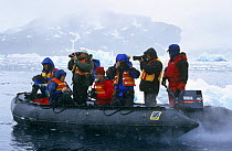 Photographers on zodiac boat with sea ice, Antarctica