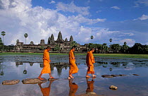 Three Buddhist monks walking at Angkor Wat temple, Angkor, World Heritage Site,
