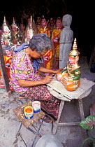 Woman painting statue made for retail, Phnom Penh, Cambodia