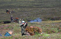 Line of guns in traditional butts on grouse shoot. Cairngorms NP, Scotland, UK