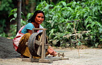 Misshing tribal woman on spinning wheel, Majuli Is, Assam, India