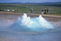 People watching Strokkur geyser erupting, Geysir, Iceland