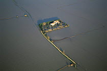 Aerial view of house cut off by flooded River Rhone, Arles Camargue, France, December 2003
