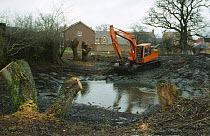 Pond management, de-silting village pond with digger, Worcestershire, UK