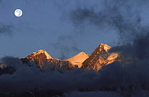Full moon at sunrise on snow-capped mountains. View from Muktinath, Mustang, Nepal November 2004