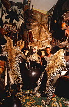 Man with serval and leopard cat skins for sale, as well as other animal products, Addis Ababa, Ethiopia