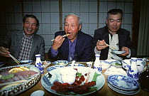 Three ex-whale fishermen enjoy a meal of Whale meat, Japan 2002
