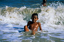 Betsimisaraka boy playing in surf, Maroantsetra, NE Madagascar