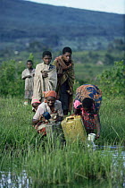 Rwandan Hutu refugees collecting drinking water, refugee camp was right on edge of Virunga NP, Democratic Republic of Congo, formerly Zaire, 1994