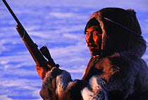Inuit hunter in Caribou / Reindeer skin clothes, Canada. Model released.