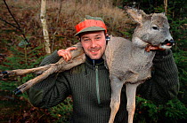 Hunter with dead Roe deer, Sweden.